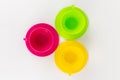 multi-colored plastic cups and plates on a white background kitchen set Royalty Free Stock Photo