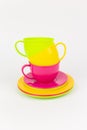 multi-colored plastic cups and plates on a white background kitchen set Royalty Free Stock Photo