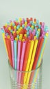 Multi colored plastic drinking straws held together against a neutral background Royalty Free Stock Photo