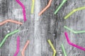 Multi colored plastic straws on black grunge background