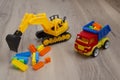 Multi-colored plastic toy. Toy truck and tractor excavator. Child Game