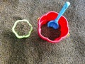 Multi-colored plastic toys in the sand. Children`s toys for games in the sand and on the beach. Bucket, spade and rake. Royalty Free Stock Photo