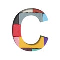Multi-colored plasticine font. Letter C cut out of paper on a background of pieces of colored plasticine. A set of volumetric