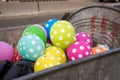 Multi-colored polka dot balloons are in the dumpster or garbage container and on one one sits fly. Party, celebration, fun, holida Royalty Free Stock Photo