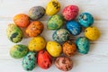 Multi-colored quail Easter eggs on a white wooden background Royalty Free Stock Photo