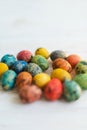 Multi-colored quail Easter eggs on a white wooden background Royalty Free Stock Photo