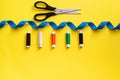 Sewing materials. Multi-colored threads, meter tape, scissors. Top View Royalty Free Stock Photo