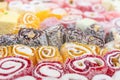 Multi-colored rolls of oriental sweets close-up, focus in the foreground. Royalty Free Stock Photo