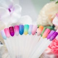 Multi-colored samples of nail tips for nail design on light background