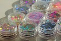 Multi colored Sequins for the design of nails in a Jar. Glitter in jars. Foil for nail service. Photo set. Sparkling beauty