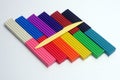 Multi-colored set of plasticine sticks and sculptural knife on white background