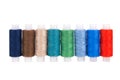 Multi-colored sewing reels stand in a row on a white background, isolated Royalty Free Stock Photo