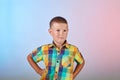 In a multi-colored shirt, a cute child on a gradient color background Royalty Free Stock Photo