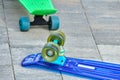 Multi-colored skateboards lie on the street on the tiles