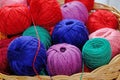 multi-colored skeins of thread in a wicker basket.