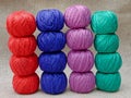 multi-colored skeins of threads stacked one on top of the other,