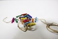 Multi-colored small cloth clamps, stacking together into a pile and one rope. The background is white