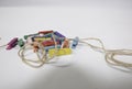 Multi-colored small cloth clamps, stacking together into a pile and one rope. The background is white