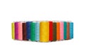 multi-colored spools of sewing thread on a white background