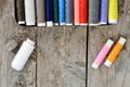 Multi-colored spools of thread on a wooden table Royalty Free Stock Photo