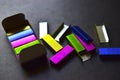 Multi-colored stapler staples on a black background