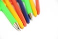 Multi-colored stationery pens for writing on a white background Royalty Free Stock Photo