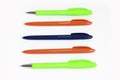 Multi-colored stationery plastic writing pens on a white background Royalty Free Stock Photo