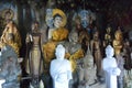 Multi-colored statuettes of Buddha in a prayer room in a pagoda Royalty Free Stock Photo