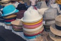 Multi-colored summer hats on the market counter