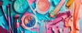 A multi-colored table with makeup products and brushes arranged in an artistic manner. The vibrant Royalty Free Stock Photo