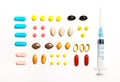 Multi-colored tablets and prick, vitamins, dietary supplements Royalty Free Stock Photo