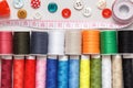 Multi-colored thread buttons measuring tape on a gray background Royalty Free Stock Photo