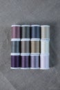 Multi colored thread spools on linen Royalty Free Stock Photo