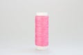 Pink threads for sewing on a white background Royalty Free Stock Photo