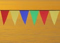 Multi Colored Triangular Flags Hanging in the Sky at an Outdoor on the background of gold water.