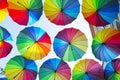 Multi-colored umbrellas background. Colorful umbrellas floating above the street. Street decoration. Royalty Free Stock Photo