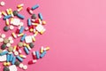 Multi-colored vitamins on a pink background Royalty Free Stock Photo