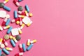 Multi-colored vitamins on a pink background Royalty Free Stock Photo