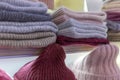 Multi-colored warm knitted hats on the shelves in the store. Close-up