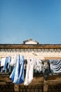 Multi-colored washed linen dries on the stone balcony of an old building. Bottom view Royalty Free Stock Photo