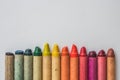 Multi-colored wax crayons on white paper Royalty Free Stock Photo