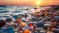 Multi-colored wet pebbles on the seashore against beautiful sunset. Empty pebble beach by the sea, sunset on the horizon