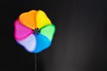 Multi-colored wind toy on a black background Royalty Free Stock Photo