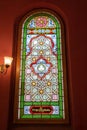 Multi-colored window stained glass inside the Jewish synagogue. Inscriptions in Polish and Hebrew Royalty Free Stock Photo