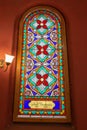 Multi-colored window stained glass inside the Jewish synagogue. Inscriptions in Polish and Hebrew Royalty Free Stock Photo