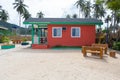 Multi-colored wooden houses on the beach with palms and white sand. Oriental architecture holiday house with large windows Royalty Free Stock Photo