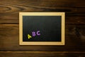 Multi-colored wooden letters Letters ABC on blackboard Royalty Free Stock Photo