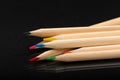 Multi-colored wooden pencils. Dark black background. Natural materials. Stationery. Office tools. Back to school. Education and