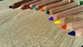 Multi-colored wooden pencils of a triangular shape in a section are intended for the development of fine motor skills of the child