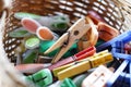 Multi-colored wooden and plastic clothespins in a wicker basket Royalty Free Stock Photo